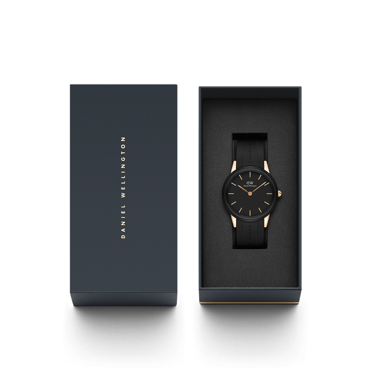 Daniel Wellington Iconic Motion Rose Gold watch with a black dial and black FKM rubber strap, presented in an elegant branded gift box.