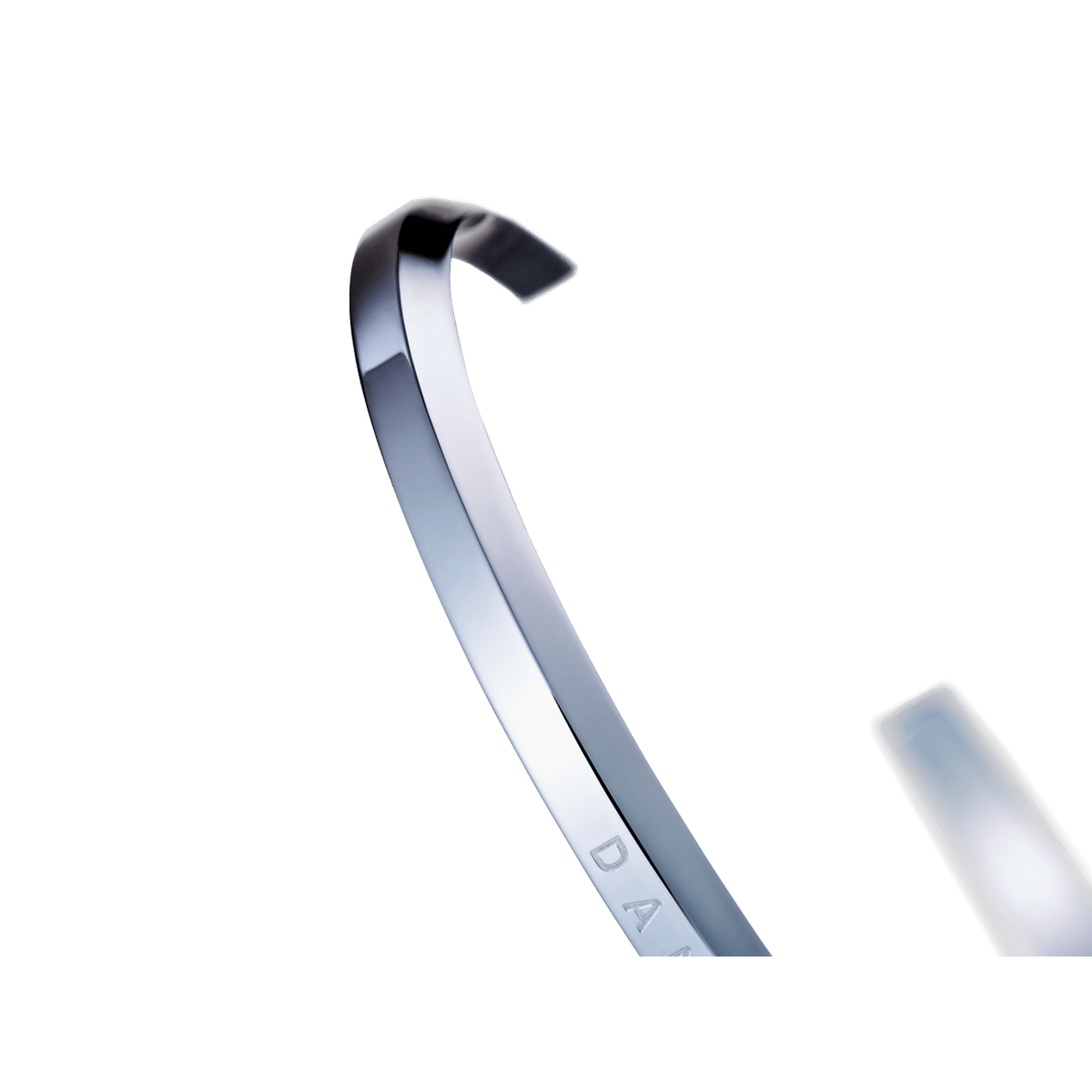 Close-up of the Classic Bracelet Silver by Daniel Wellington, highlighting the polished stainless steel finish and engraved detail on the slim open cuff.