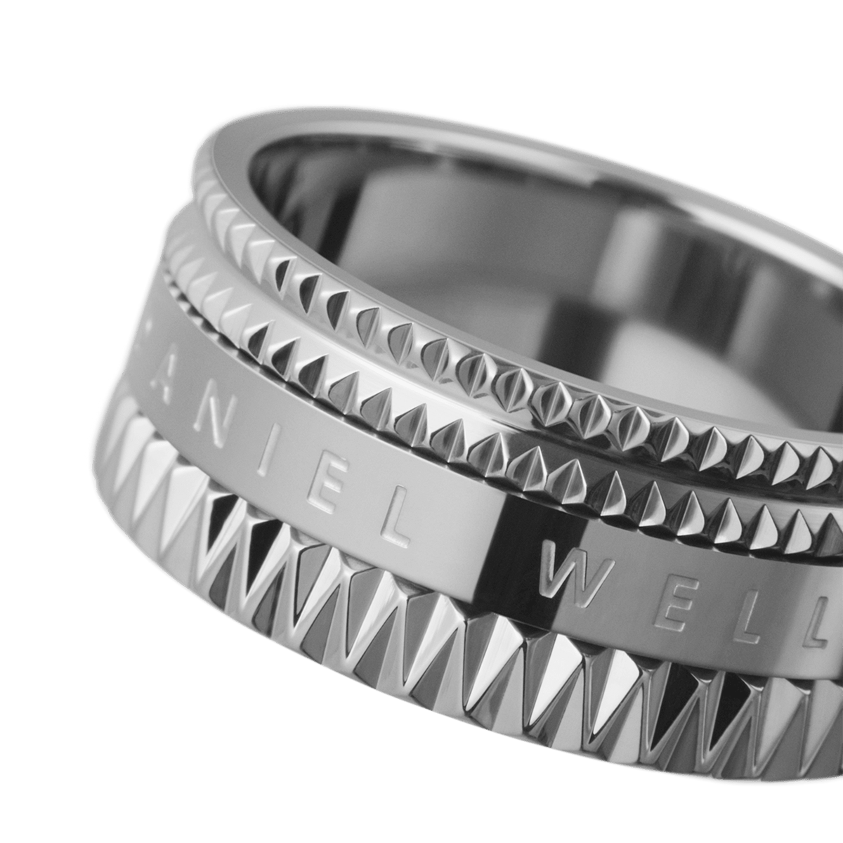 Close-up of the Elevation Ring Silver by Daniel Wellington, highlighting the geometric textured edges and polished engraved centre on the wide stainless steel band.