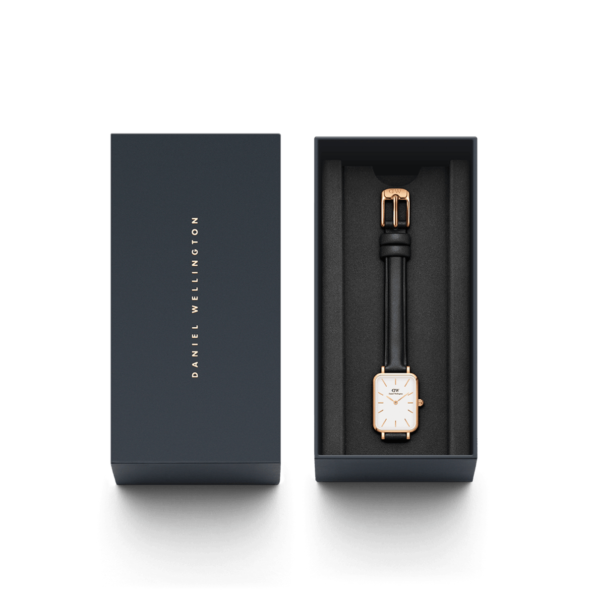 Quadro Pressed Sheffield Rose Gold watch with a rectangular white dial and black leather strap, elegantly presented in a Daniel Wellington branded gift box.