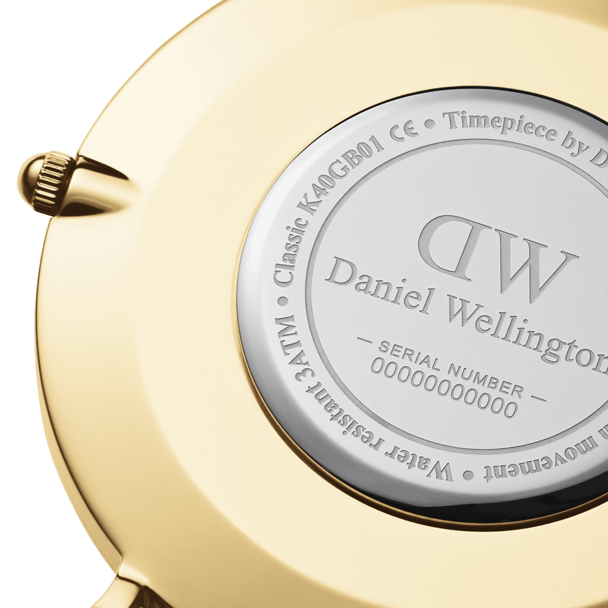 Close-up of the Classic Sheffield Gold watch case back, showing the engraved Daniel Wellington branding, water resistance details, and serial number on a polished gold finish.