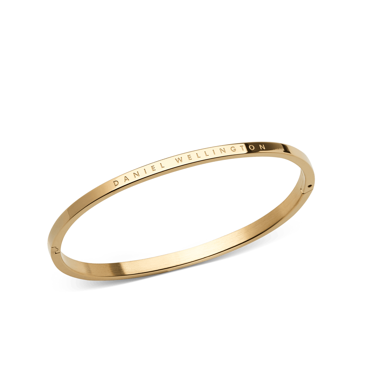 Classic Bangle Gold features a slim, minimalist design with a polished gold finish and Daniel Wellington branding engraved on the outer edge, shown at an angle to highlight its elegant profile.