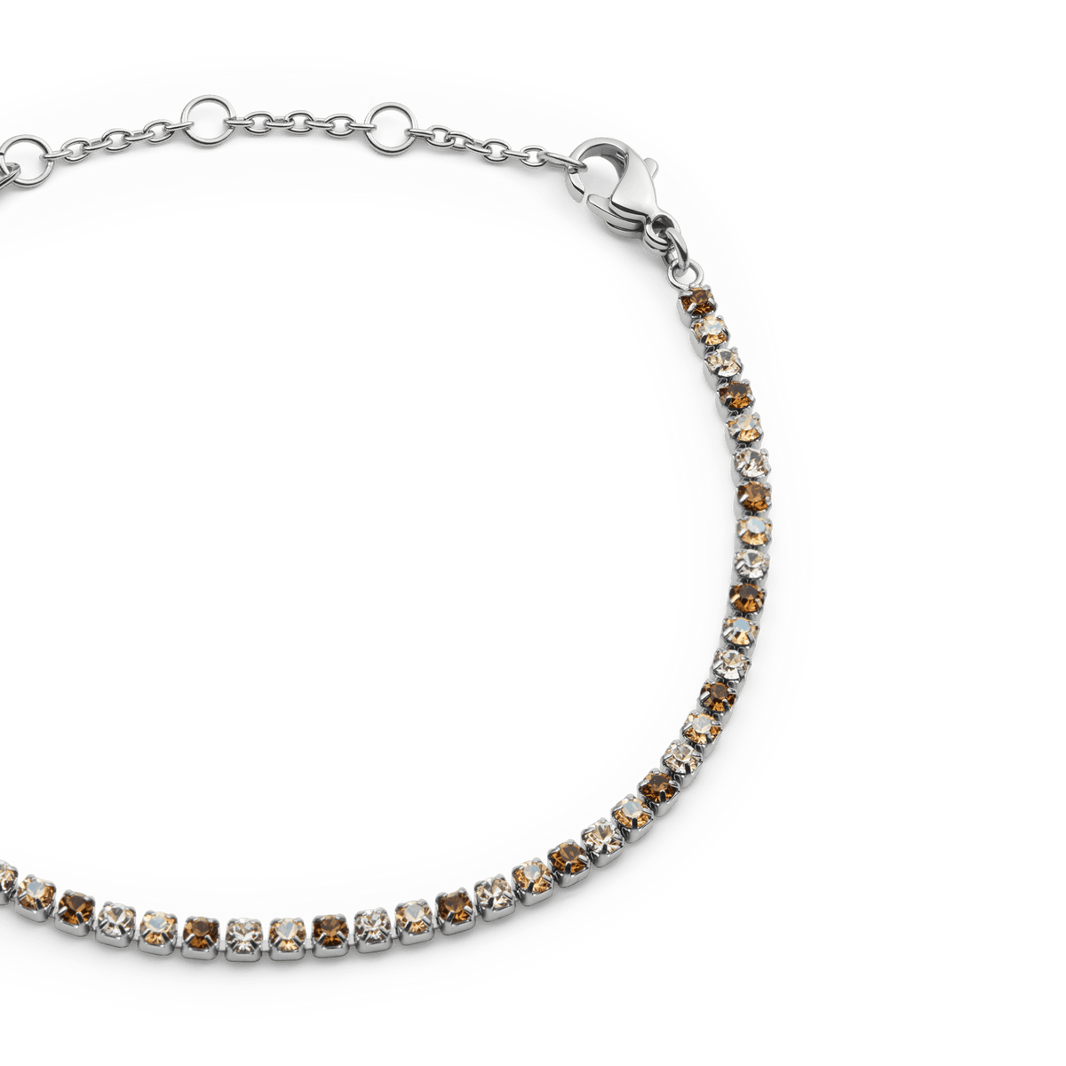 Close-up of the Classic Tennis Bracelet Honey Combo Silver, showing alternating honey and clear crystals set in a slim silver chain with an adjustable lobster clasp.