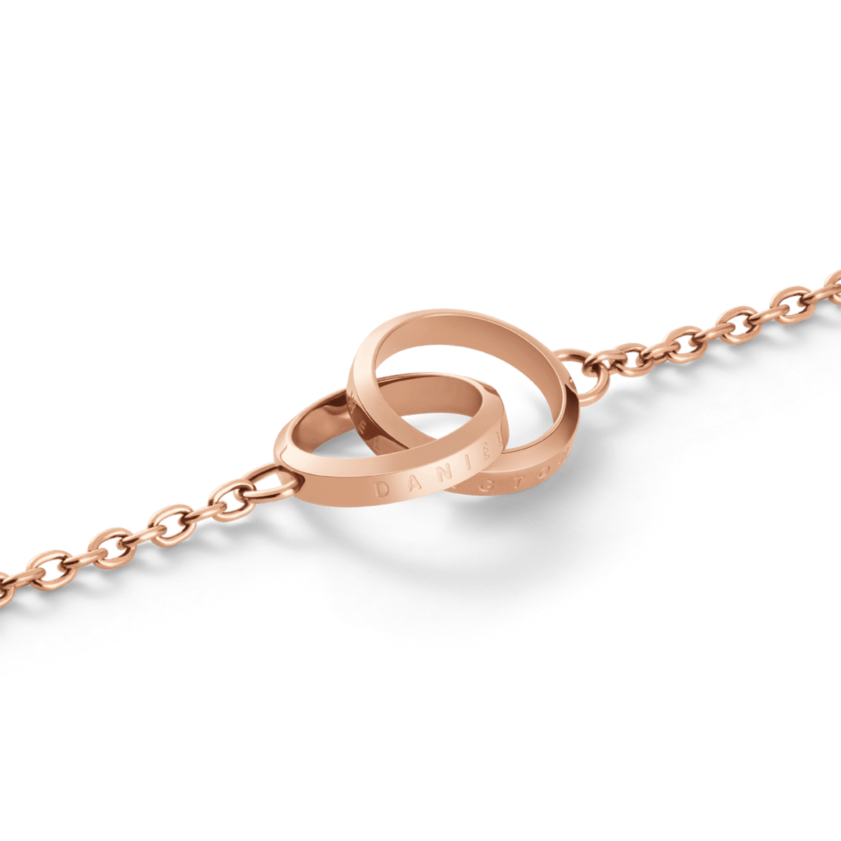 Close-up of the Elan Unity Bracelet Rose Gold showing two polished interlocking rings engraved with branding, attached to a fine rose gold chain.