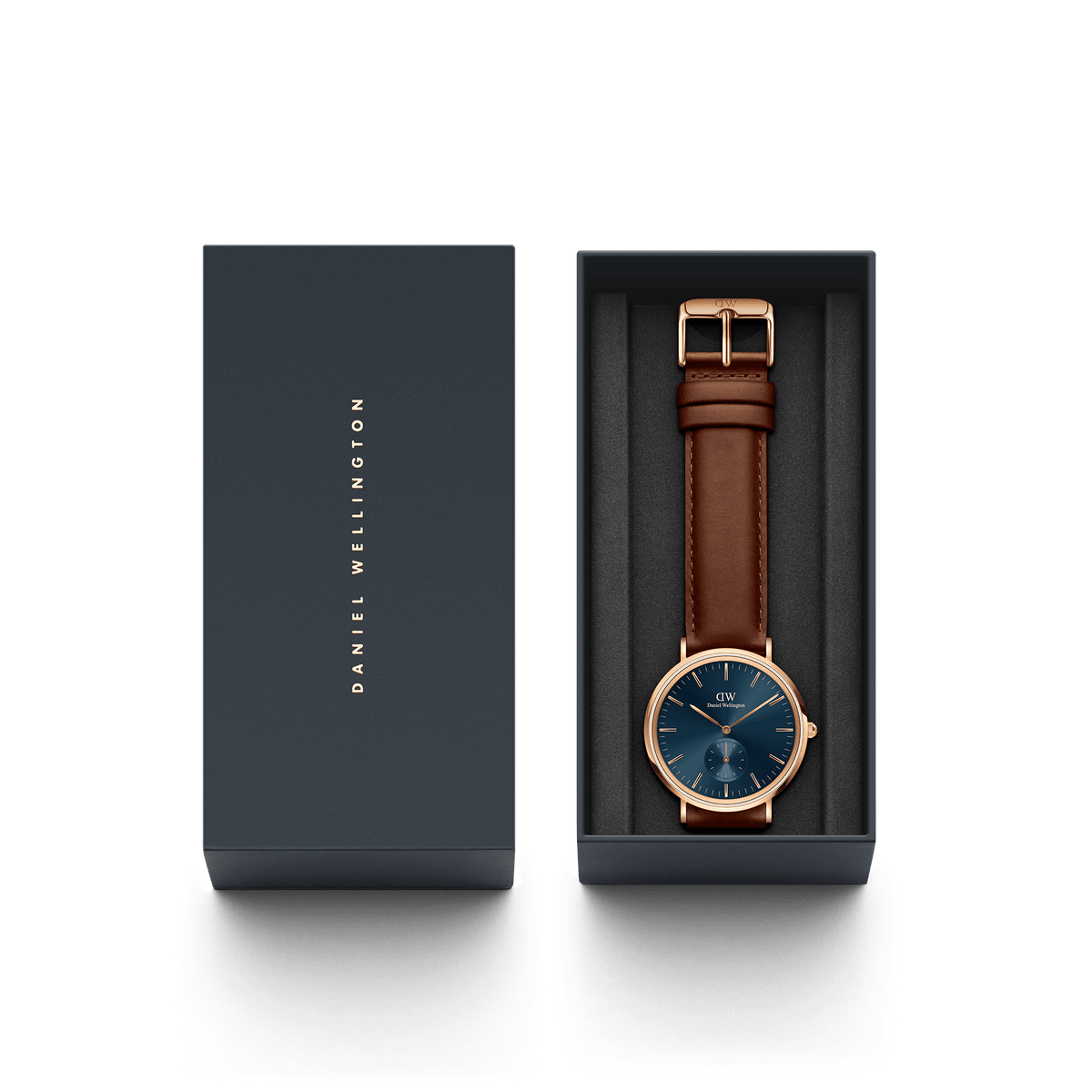 Classic Multi-Eye St Mawes Arctic Rose Gold men's watch with a blue chronograph dial and brown leather strap, presented in a sleek Daniel Wellington gift box.