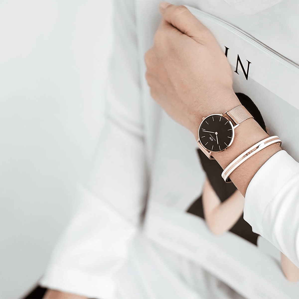 Emalie Slim Bracelet Rose Gold styled on a wrist alongside a rose gold mesh watch, showing its minimalist rose gold and white enamel design paired for a modern, elegant look.