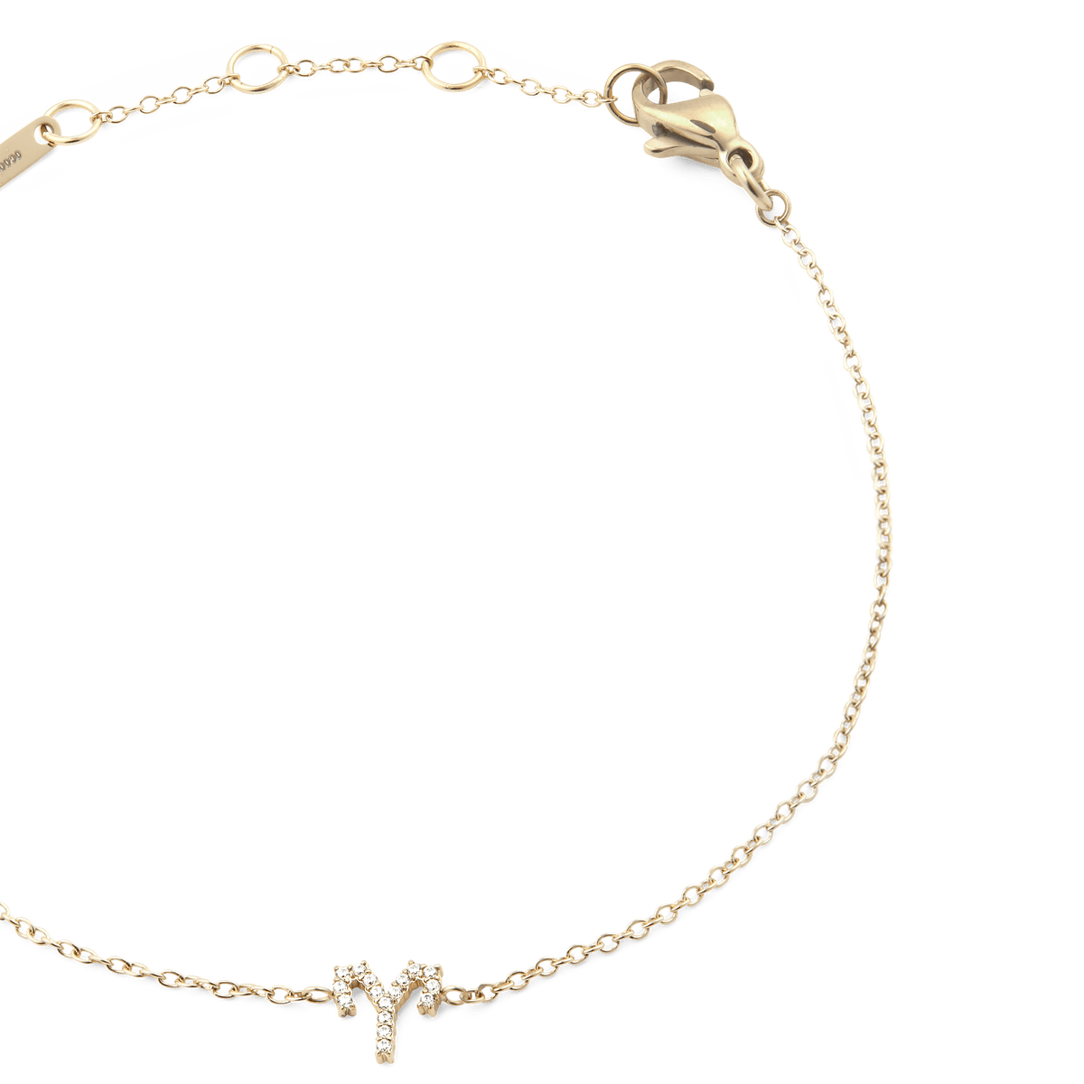 Close-up of the Crystal Zodiac Chain Bracelet Gold, featuring a fine gold chain with adjustable sizing rings and a crystal-encrusted Aries zodiac charm at the centre.