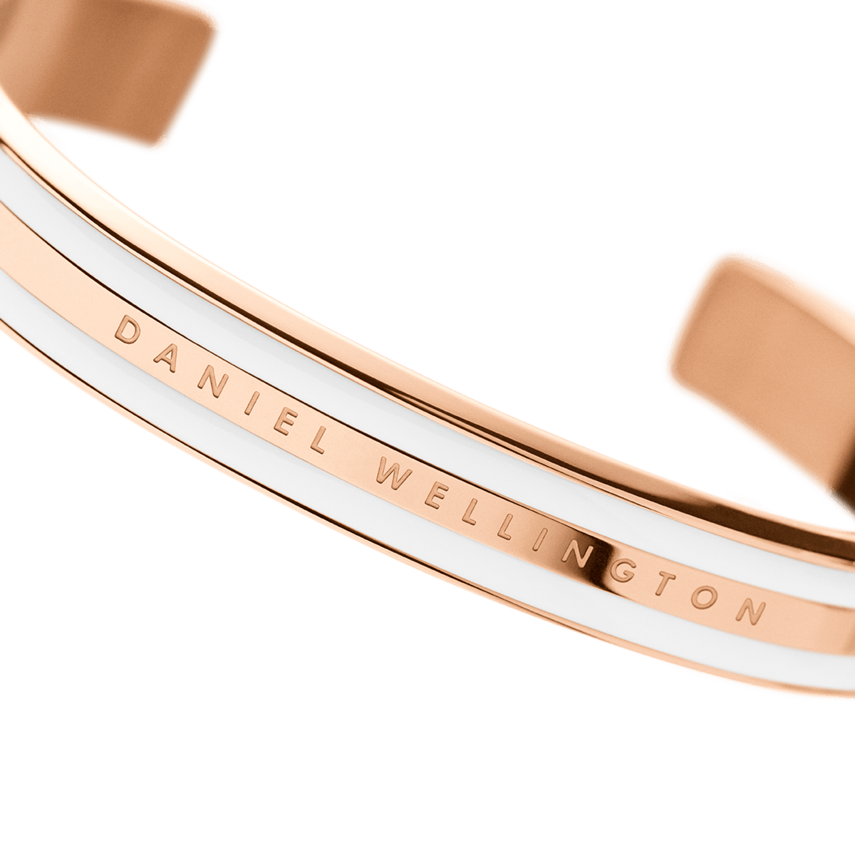 Close-up of the Emalie Bracelet Satin White Rose Gold, highlighting the engraved Daniel Wellington logo and the sleek satin white enamel and rose gold finish.