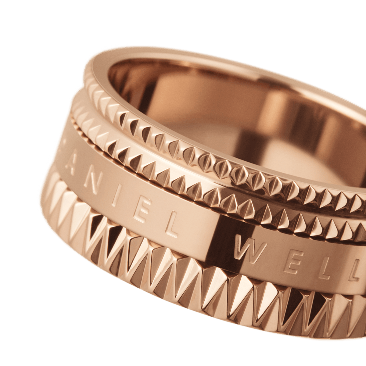 Close-up of the Elevation Ring Rose Gold, highlighting its polished rose gold finish, geometric textured edges, and engraved Daniel Wellington logo.