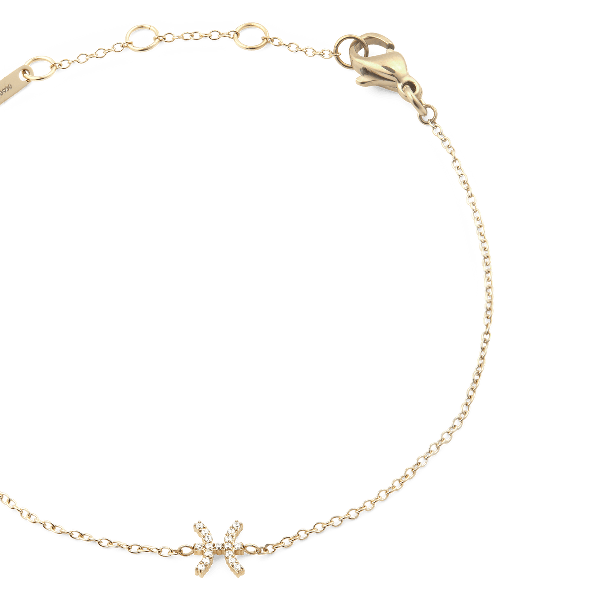 Close-up of the Crystal Zodiac Chain Bracelet Gold, highlighting the slim gold chain, adjustable sizing rings, and a sparkling Pisces zodiac charm set with crystals.