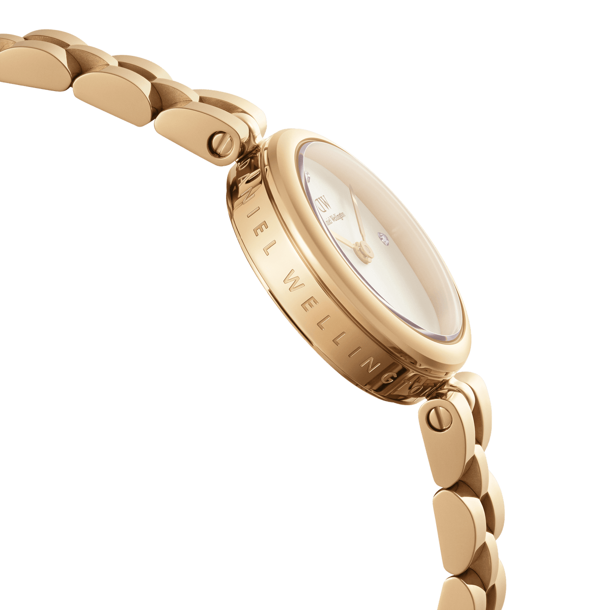 Close-up side view of the Elan Lumine Gold watch, showing the engraved Daniel Wellington branding on the gold case, crystal-accented white dial, and the polished three-link gold bracelet.
