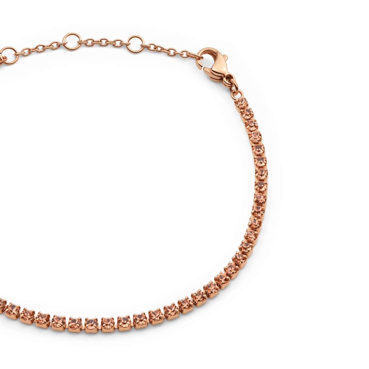 Close-up of the Classic Tennis Bracelet Apricot Rose Gold, featuring a row of apricot-coloured crystals set in rose gold with an adjustable chain and secure lobster clasp.