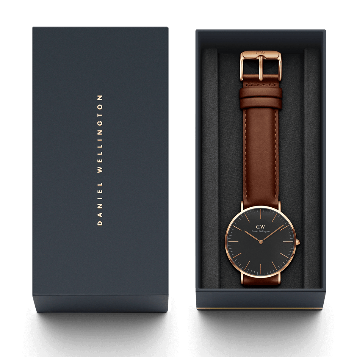 Classic St Mawes Black Rose Gold watch with a brown leather strap and black dial, presented in a Daniel Wellington gift box with gold branding.