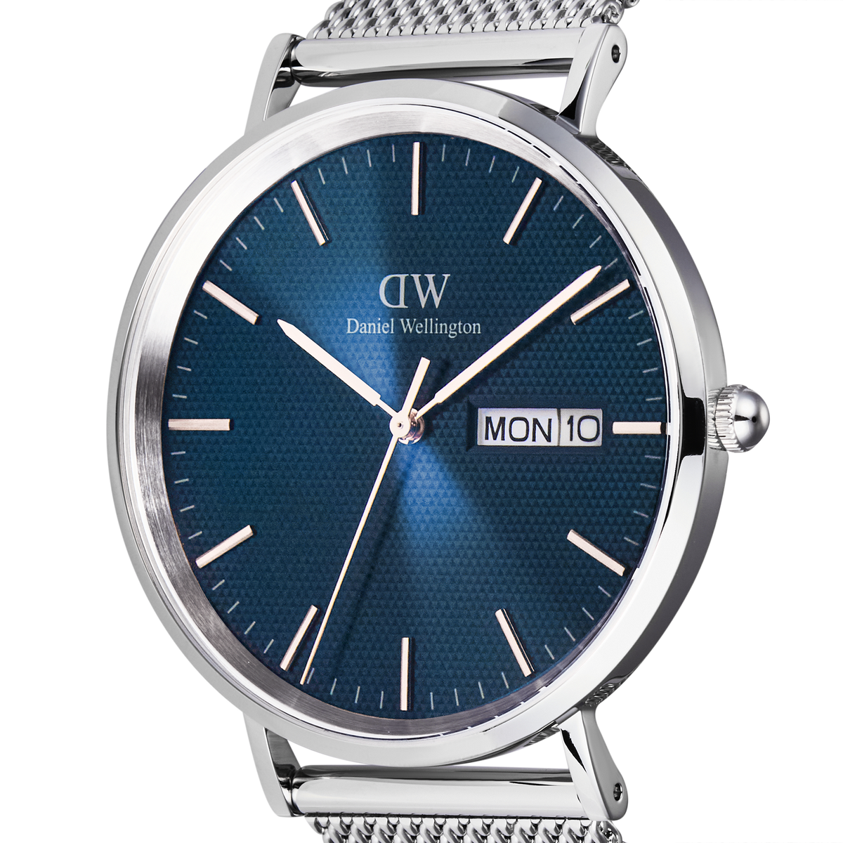 Close-up of the Classic Day Display Sterling Arctic watch showing the blue dial with a semi-transparent triangle pattern, silver hour markers, and a day and date window.