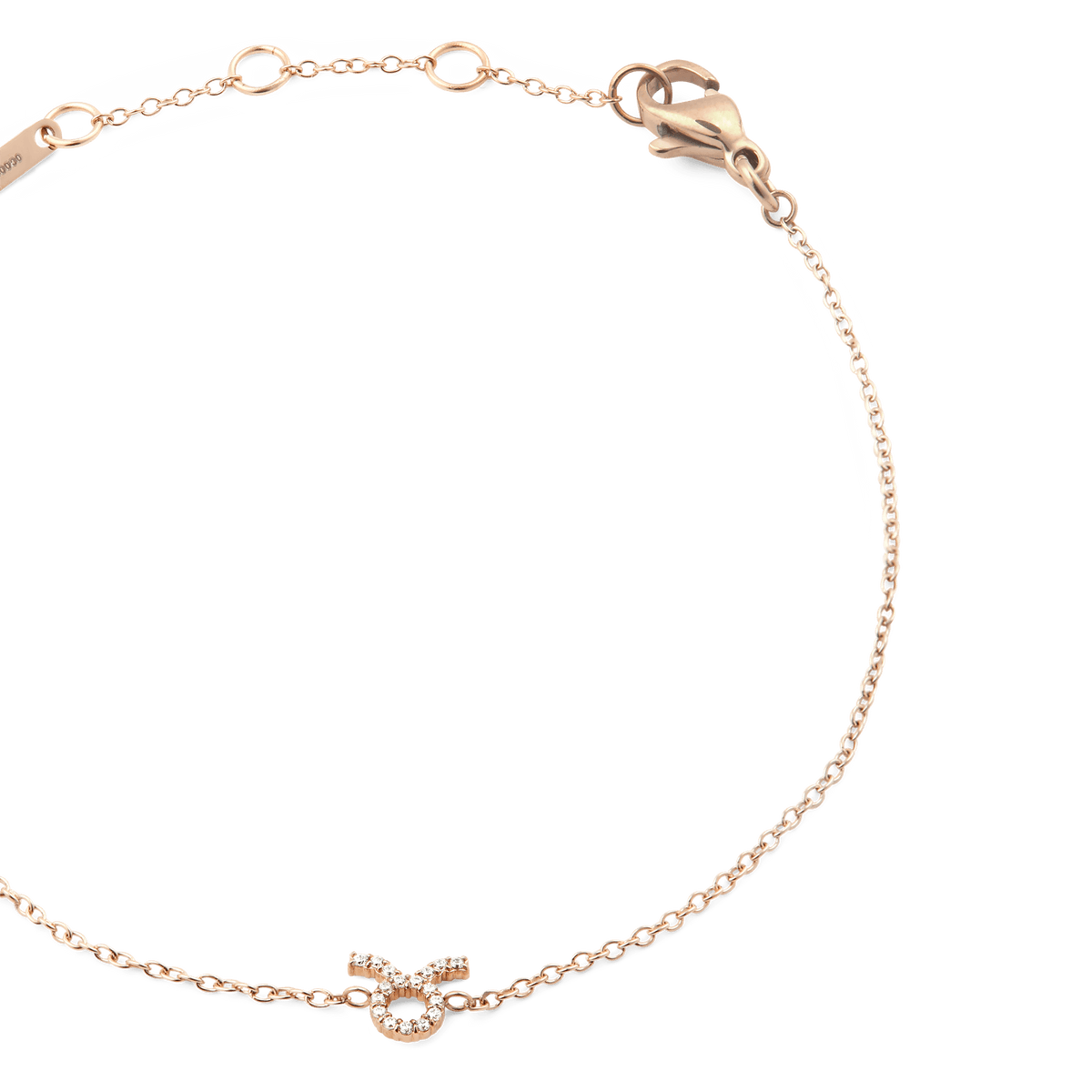 Close-up of the Crystal Zodiac Chain Bracelet Rose Gold, featuring a fine rose gold chain with adjustable sizing rings and a crystal-set Taurus zodiac pendant.