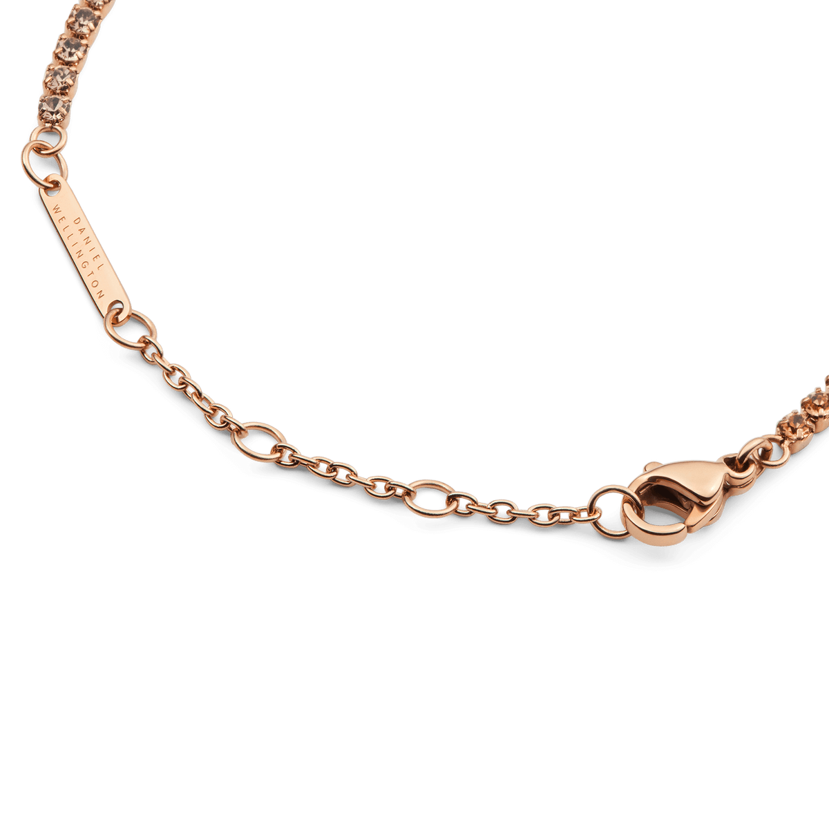 Detail view of the Classic Tennis Bracelet Apricot Rose Gold, highlighting the adjustable chain, lobster clasp, and individually set apricot-coloured crystals.