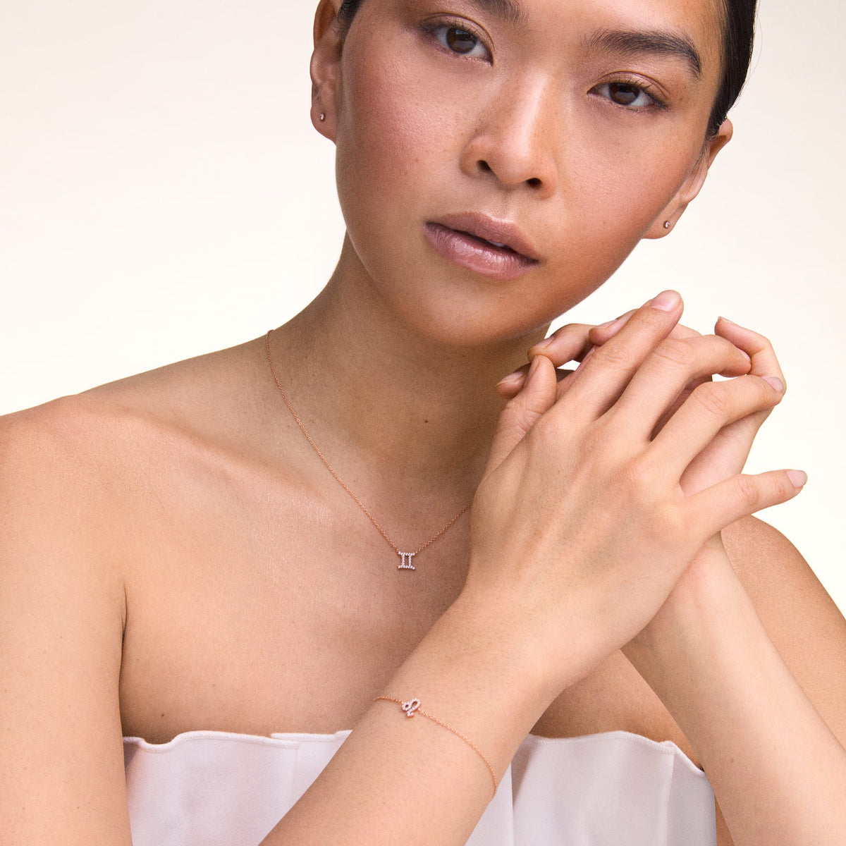 Woman wearing the Crystal Zodiac Chain Bracelet Gold with a Leo zodiac charm and sparkling crystals, styled alongside a Gemini zodiac necklace for a refined, personalised look.