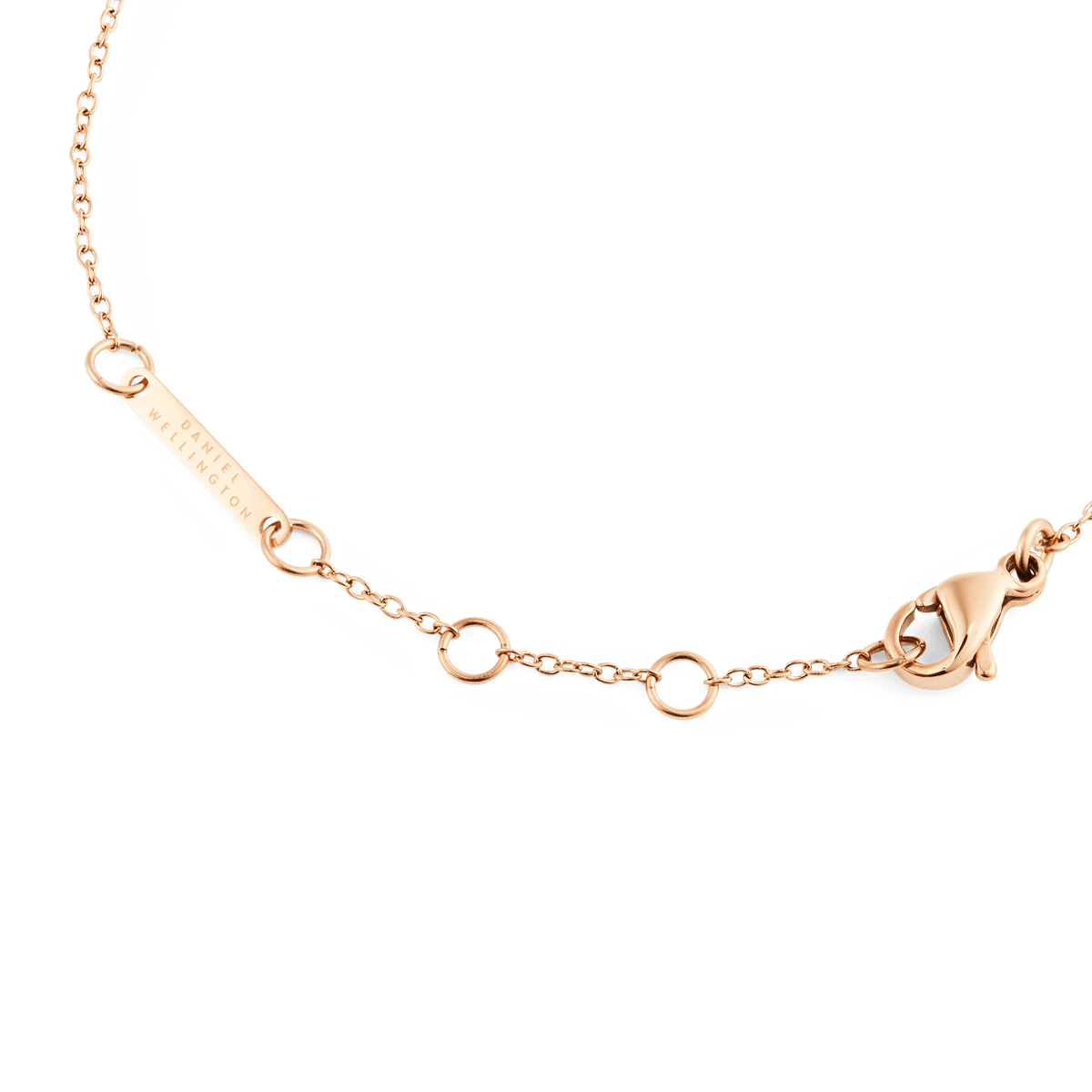 Detail of the Mirelle Solitaire Bracelet Rose Gold showing the adjustable rose gold chain, secure clasp, and Daniel Wellington engraved tag.