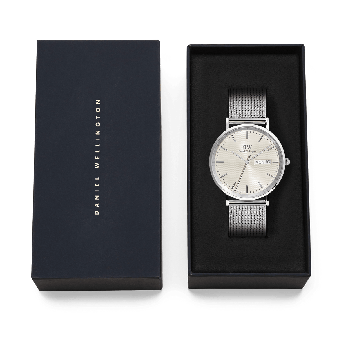 Classic Day Display Sterling Champagne men’s watch with a silver mesh strap and champagne dial, presented in a Daniel Wellington gift box, ideal for gifting or special occasions.