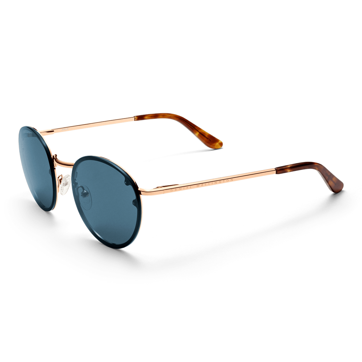 Arch Steel Blue Rose Gold sunglasses with round blue UV400 nylon lenses, rose gold plated stainless steel frame, adjustable silicone nose pads, and tortoiseshell acetate temple tips, presented in a three-quarter view.