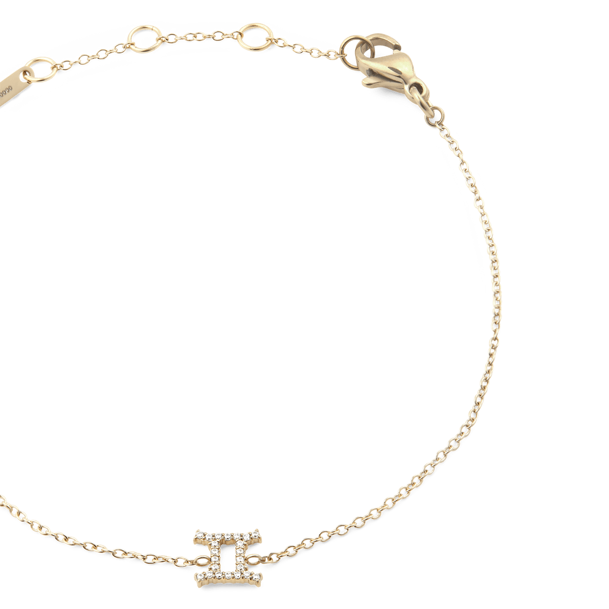 Close-up of the Crystal Zodiac Chain Bracelet Gold with a fine gold chain, adjustable sizing rings, and a crystal-encrusted Gemini zodiac charm at the centre.