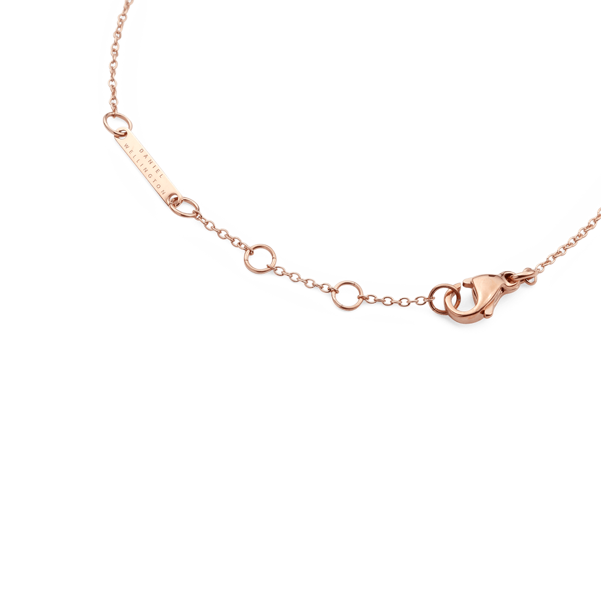 Detail of the Crystal Zodiac Chain Bracelet Rose Gold showing the adjustable sizing rings, secure lobster clasp, and engraved Daniel Wellington tag on a slim rose gold chain.