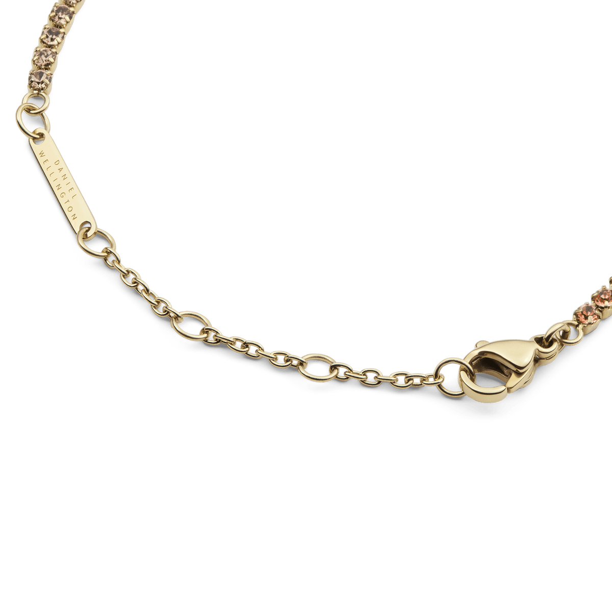 Detail of the Classic Tennis Bracelet Apricot Gold showing the gold lobster clasp, adjustable sizing rings, and individually set apricot-coloured crystals.