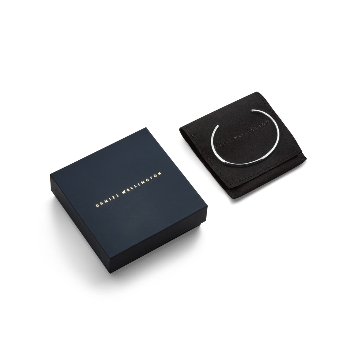 Arch Cuff Silver 6mm displayed on a branded black pouch next to a premium Daniel Wellington gift box, highlighting its polished silver finish and elegant presentation for gifting.
