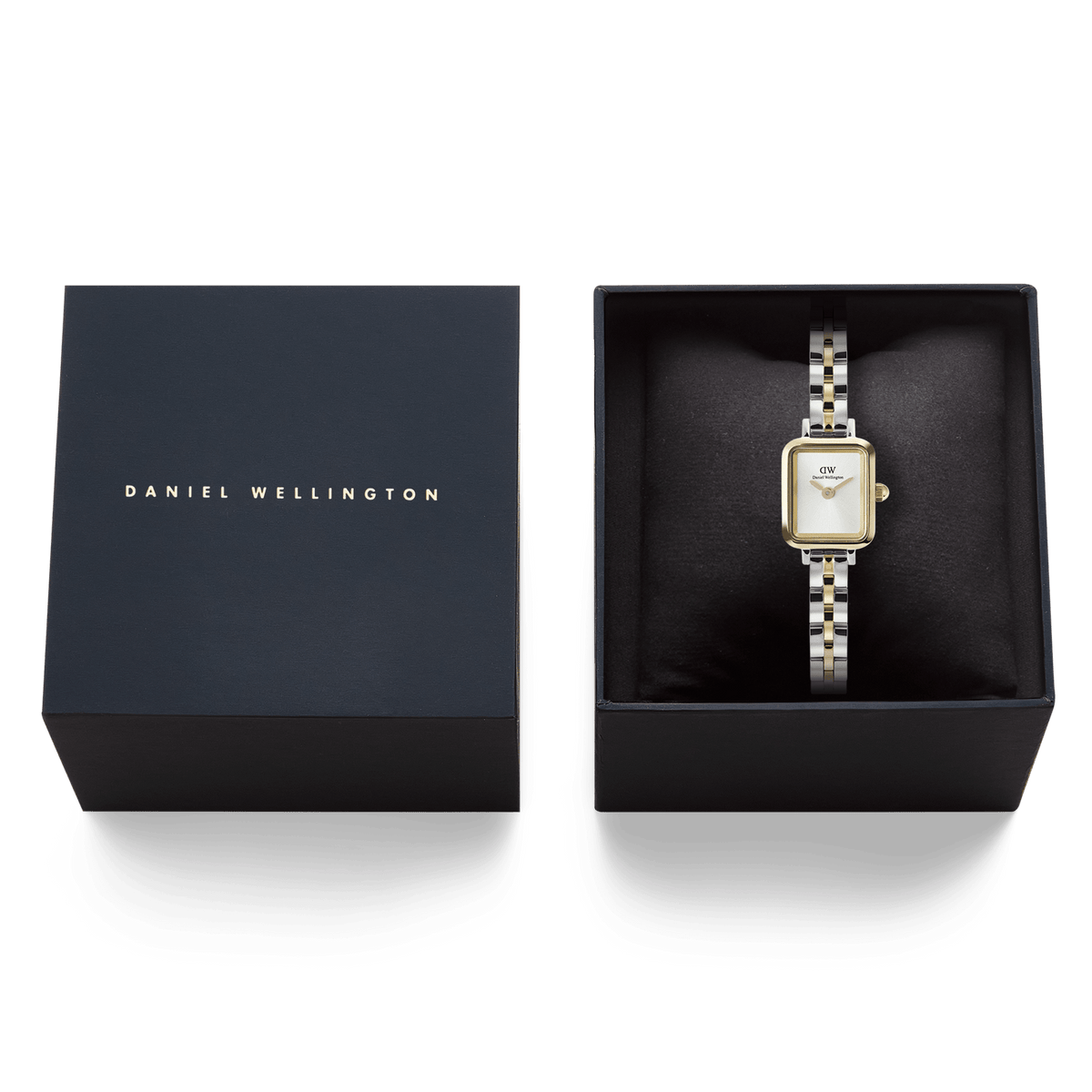 Quadro Mini Arch 3-Link Two Tone Gold ladies watch presented in a Daniel Wellington gift box, showcasing its gold and silver rectangular case and polished 3-link bracelet against a black cushion.