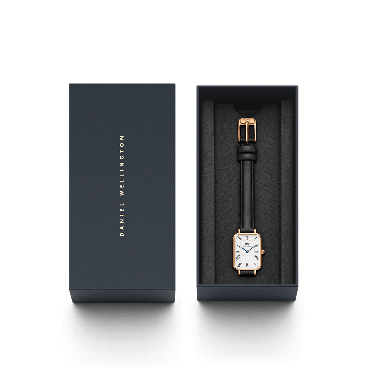 Quadro Roman Numerals Sheffield Rose Gold ladies watch presented in a sleek Daniel Wellington gift box, featuring a rectangular rose gold case, white dial with Roman numerals, and a slim black leather strap.
