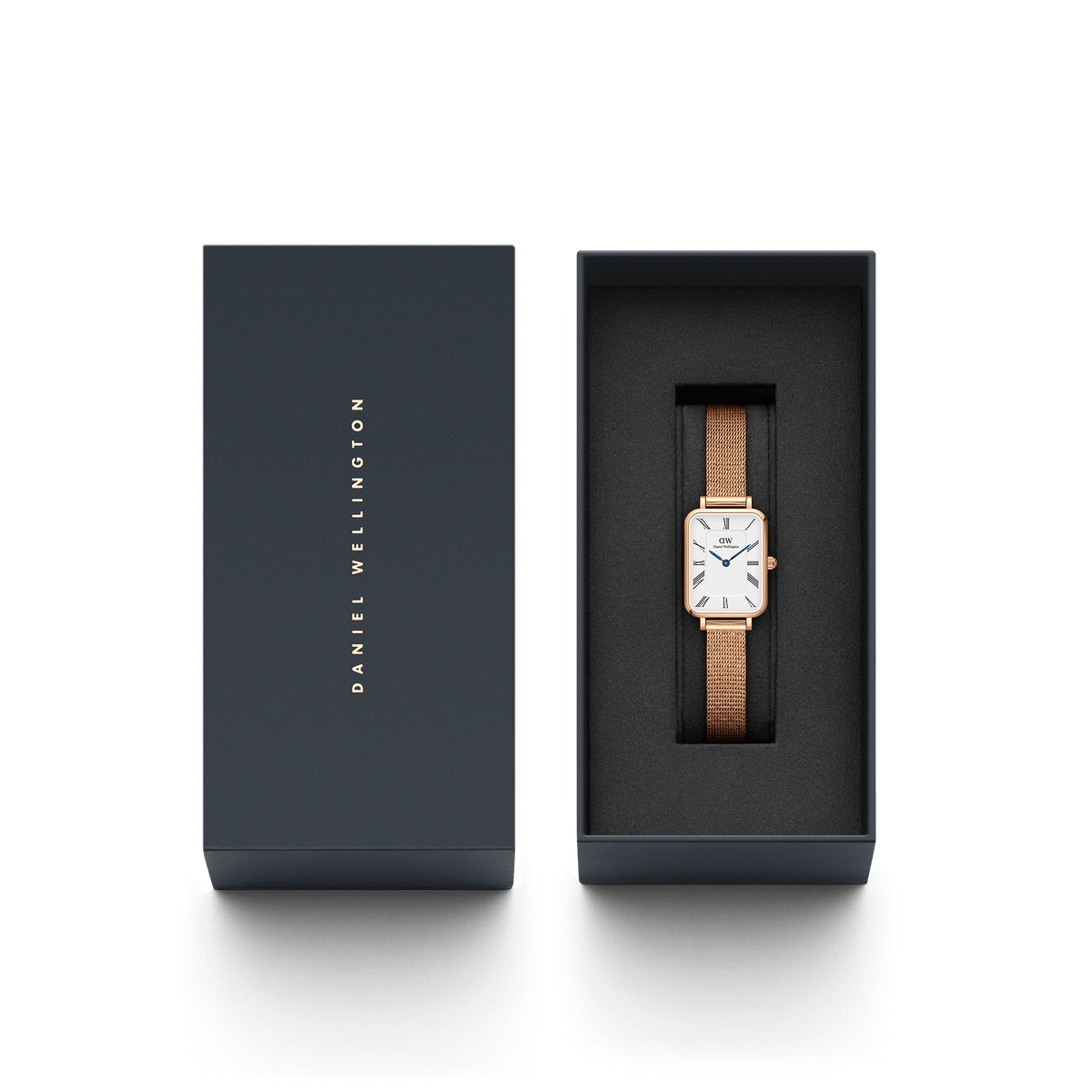 Quadro Roman Numerals Melrose watch with a rose gold mesh strap and rectangular white dial, elegantly presented in a branded gift box, ideal for gifting or special occasions.
