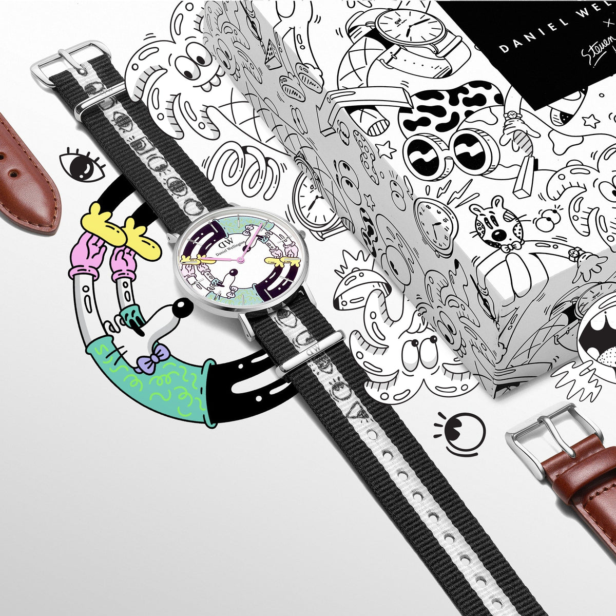 Steven Harrington x Daniel Wellington limited edition watch set featuring a multicolour printed dial, black and white illustrated NATO strap, brown leather strap, and collectible packaging with playful artwork.
