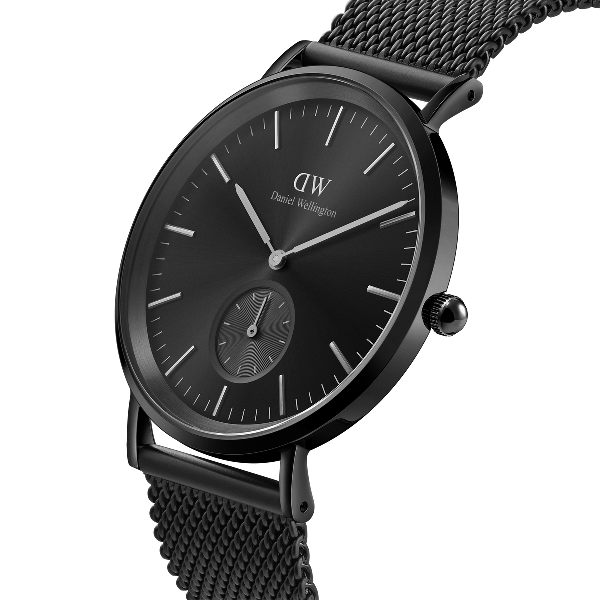 Classic Multi-Eye Ashfield Onyx men's watch with a 40mm black dial, minimalist hour markers, and a black mesh stainless steel strap, shown in a close-up angled view highlighting its sleek, modern design.
