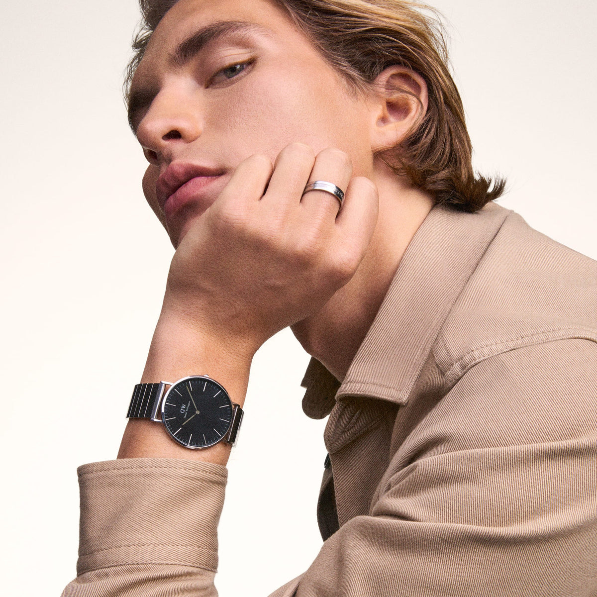 A man wearing the Classic Piano Link Onyx Silver watch, featuring a brushed black dial and geometric silver piano link strap, styled with a beige shirt for a modern, everyday look.
