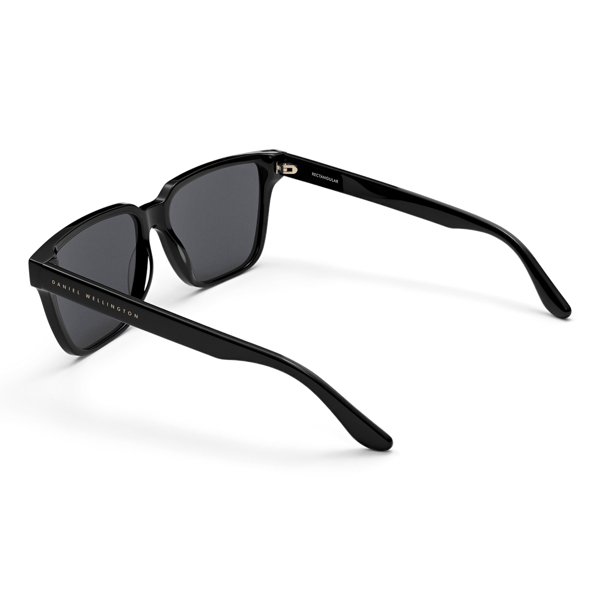 Rectangular Bio-Acetate Black sunglasses with a contemporary oversized frame, featuring dark lenses and Daniel Wellington branding along the temple for a stylish, durable finish.