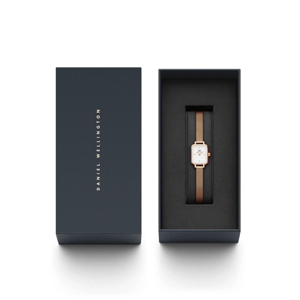 Quadro Mini Melrose watch with a rose gold mesh strap and rectangular white dial, elegantly presented in a branded Daniel Wellington gift box.