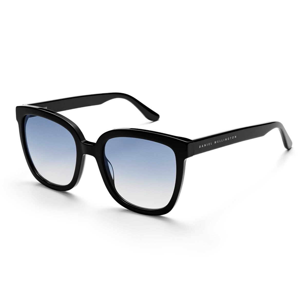 Grande Bio-Acetate Black Blue sunglasses featuring an oversized square black frame, blue gradient UV400 lenses, and Daniel Wellington branding on the arm, designed for stylish comfort and reliable sun protection.