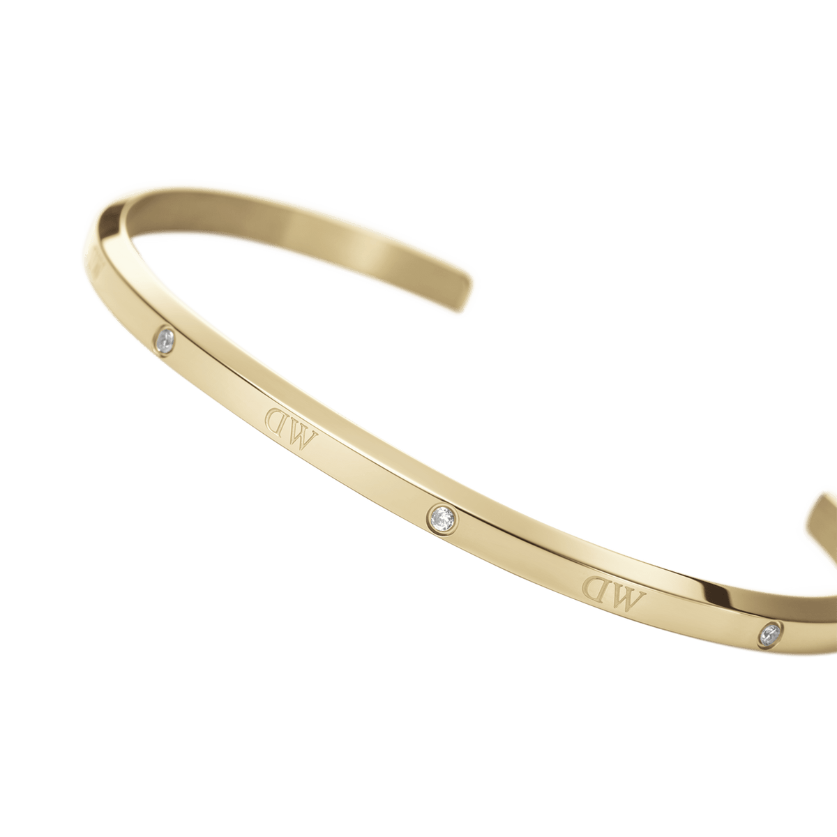 Classic Lumine Bracelet G shown in a curved angle, highlighting its slim gold cuff, polished finish, and six sparkling crystals for a refined, minimalist look.