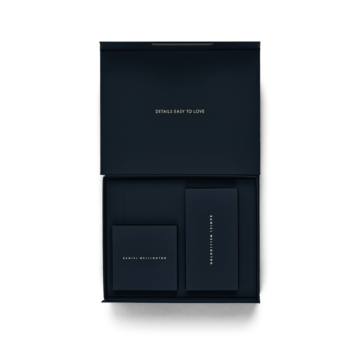 Premium Gift Box Blue opened to reveal a neatly organised interior with compartments and matching cards, featuring gold Daniel Wellington branding and the phrase