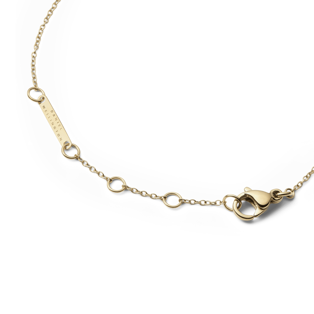Detail of the Audrey Bracelet Tiger Eye Gold showing the adjustable gold chain with multiple sizing rings, a secure lobster clasp, and a small Daniel Wellington tag.