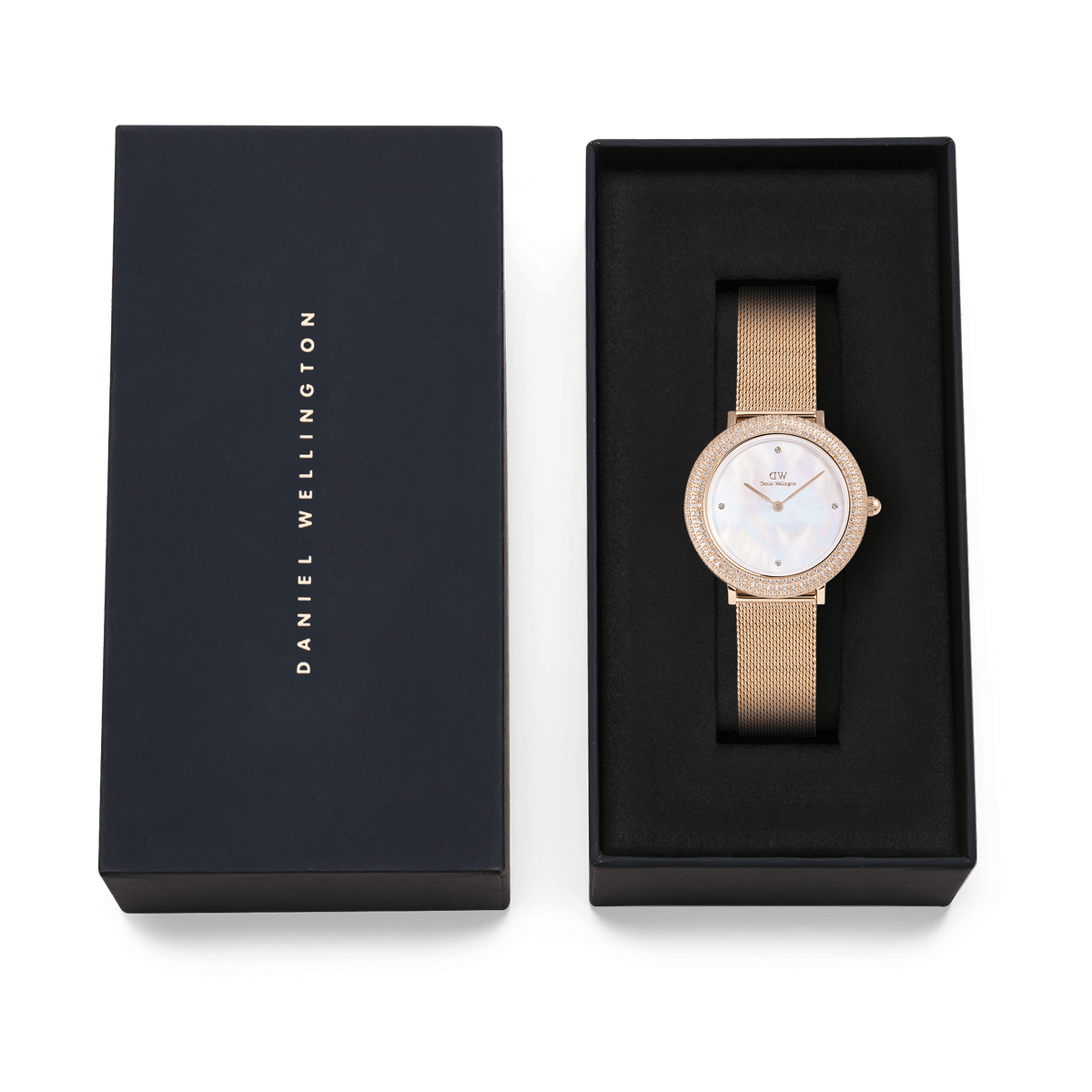 Crystalline Bezel Melrose rose gold ladies watch with a crystal-set bezel and mesh strap, elegantly presented in a black Daniel Wellington gift box.