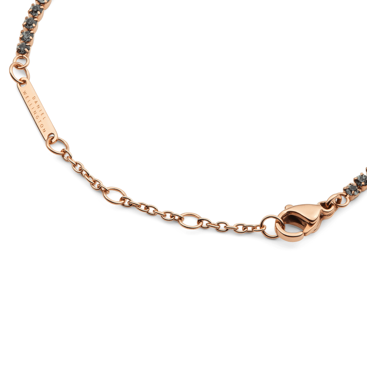Detail view of the Classic Tennis Bracelet Nightfall Rose Gold showing the rose gold lobster clasp, adjustable sizing rings, and individually set dark Preciosa crystals for a secure and elegant finish.