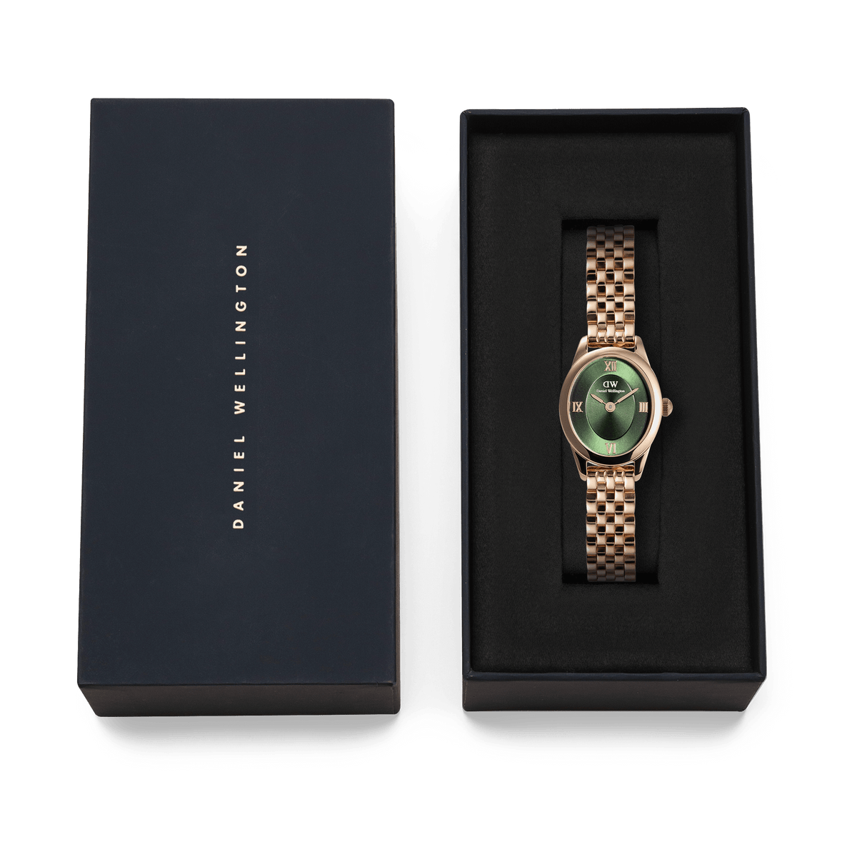 Ophelia Mini Emerald Rose Gold watch with an oval case and beans link bracelet, presented in a black Daniel Wellington gift box, highlighting its emerald green dial and polished rose gold finish.