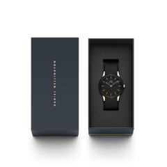 Daniel Wellington Iconic Motion Rose Gold watch with a black dial and black FKM rubber strap, presented in an elegant branded gift box.