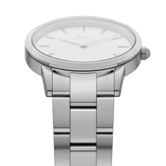 Close-up side view of the Daniel Wellington Iconic Link Silver watch, highlighting the brushed stainless steel three-piece link bracelet and the slim, polished case with minimalist eggshell white dial.