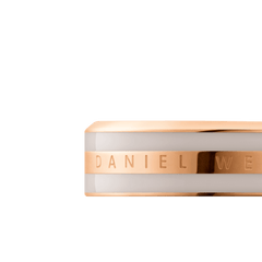 Close-up of the Emalie Ring Desert Sand Rose Gold, showing the engraved Daniel Wellington logo on a polished rose gold band with a smooth desert sand enamel inlay.