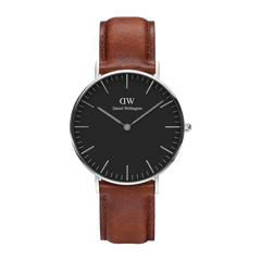 Classic St Mawes Black Silver watch featuring a slim polished silver case, minimalist black dial with silver markers, and a genuine brown leather strap.