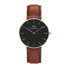 Classic St Mawes Gold watch with a slim gold-plated case, matte black dial, minimalist gold hour markers, and a brown leather strap suitable for both formal and casual wear.