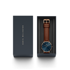 Classic St Mawes Arctic Rose Gold watch with a blue dial and brown leather strap, elegantly presented in a branded Daniel Wellington gift box.
