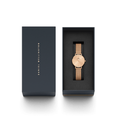 Petite Unitone Rose Gold watch with a rose gold mesh strap, presented in a sleek black Daniel Wellington gift box, highlighting its elegant design and premium packaging.